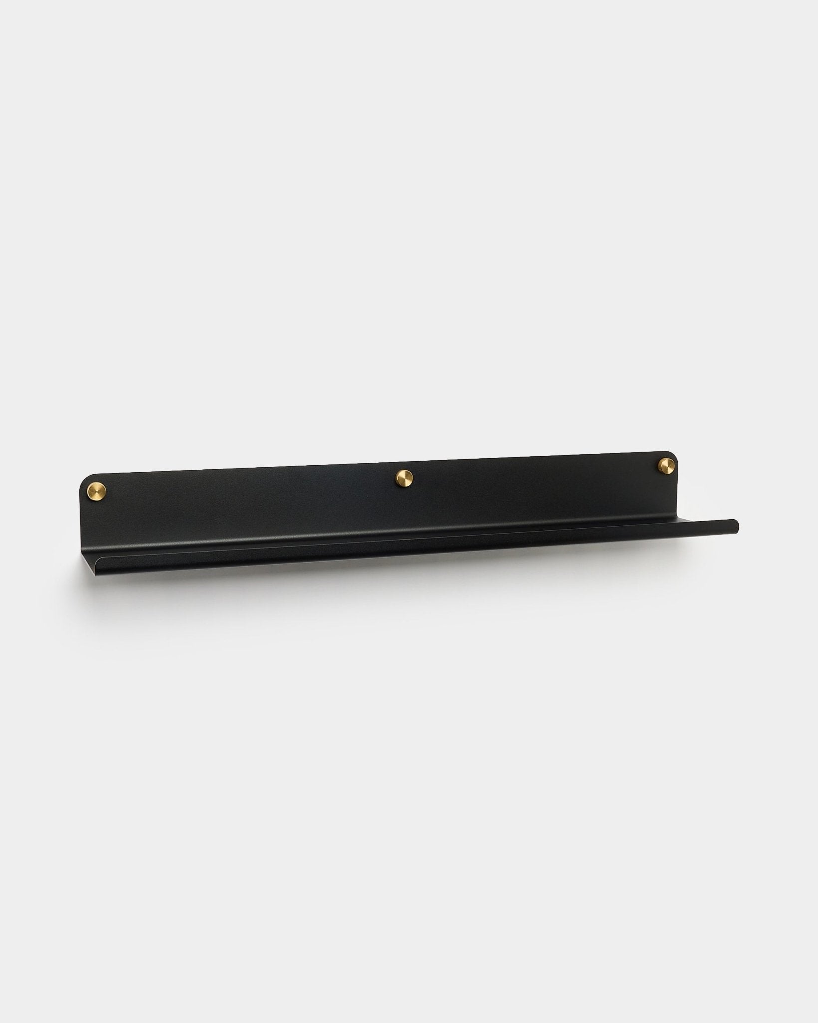 The Norr wide shelf in black (75.9 cm) by WoodUpp, made of galvanized steel with three gold screws, accessory for Akupanel, shown on plain white background.